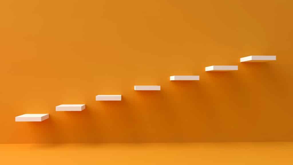 yellow wall with white steps going up from left to right